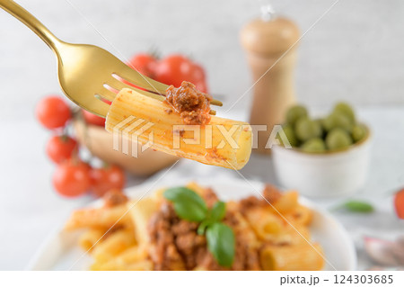 Traditional rigatoni Bolognese on fork close up Traditional rigatoni Bolognese on fork close up 124303685
