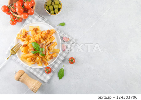 Italian rigatoni pasta with beef Bolognese sauce and basil 124303706