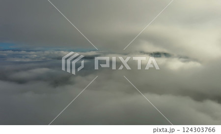 Aerial view of clouds and mountains at sunrise Aerial view of clouds and mountains at sunrise 124303766