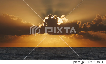 Sunrise over sea with illuminating clouds Sunrise over sea with illuminating clouds 124303811