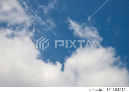 White clouds on the blue sky perfect for the background. Clear blue sky and white clouds. Blue sky background with clouds. 124303915