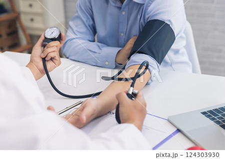 Doctor measuring blood pressure of the patient in the hospital, Medical and health care concepts. Doctor measuring blood pressure of the patient in the hospital, Medical and health care concepts. 124303930