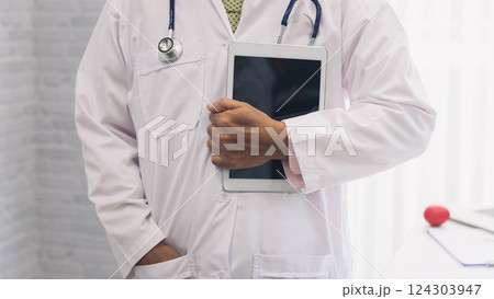 Doctor standing with stethoscope and holding tablet computer. Technology and medical concept. 124303947