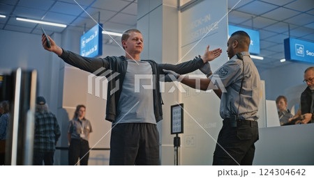 Security Officer Inspecting Young Man with Bionic Prosthetic Leg for Boarding Flight 124304642