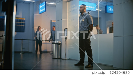 Security Checkpoint in Airport Terminal: Security Officer Inspecting Young Man with Prosthesis Leg Security Checkpoint in Airport Terminal: Security Officer Inspecting Young Man with Prosthesis Leg 124304680