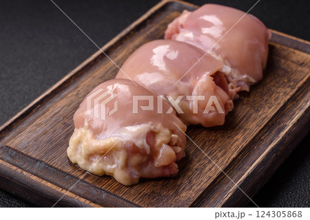 Fresh raw chicken thigh fillets with salt, spices and herbs Fresh raw chicken thigh fillets with salt, spices and herbs 124305868