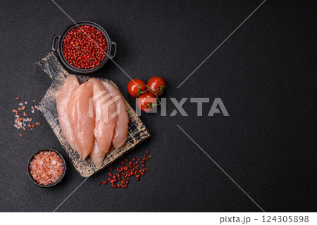 Raw chicken fillet cut into strips with spices and herbs 124305898