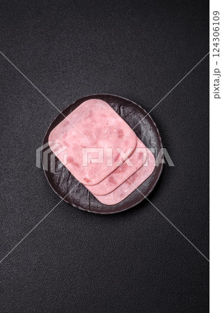Boiled ham with salt and spices cut into slices 124306109