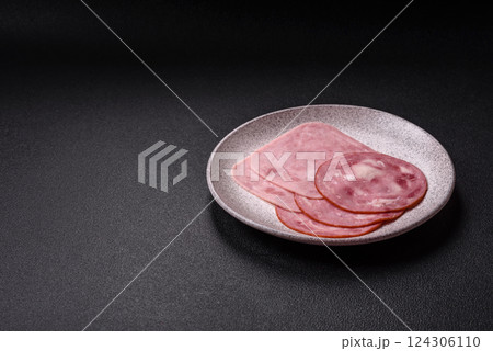 Boiled ham with salt and spices cut into slices 124306110