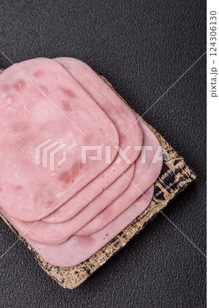 Boiled ham with salt and spices cut into slices 124306130