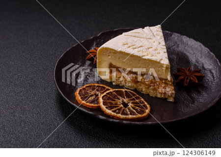 Piece of cheesecake with nuts and berries with winter pattern Piece of cheesecake with nuts and berries with winter pattern 124306149
