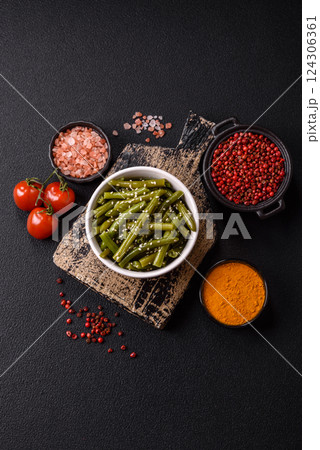Steamed green beans on a plate with olive oil, sesame seeds 124306361