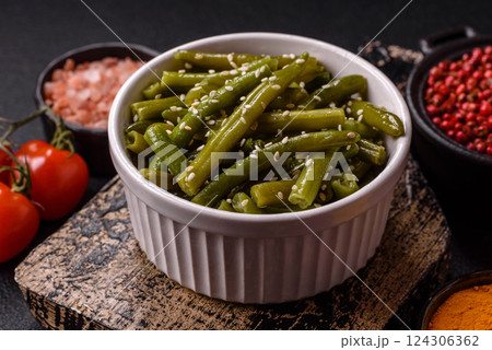 Steamed green beans on a plate with olive oil, sesame seeds 124306362