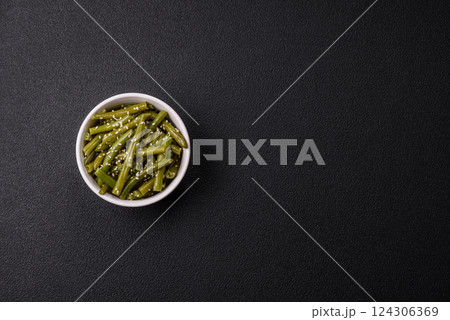 Steamed green beans on a plate with olive oil, sesame seeds Steamed green beans on a plate with olive oil, sesame seeds 124306369