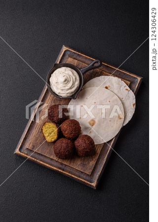 Fried chickpea falafel balls with salt, spices and herbs Fried chickpea falafel balls with salt, spices and herbs 124306429