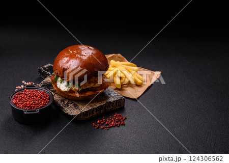 Delicious burger with beef patty, fried egg, bacon, herbs, sauce, salt and spices 124306562