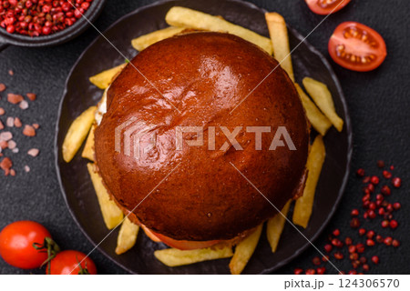 Delicious burger with beef patty, fried egg, bacon, herbs, sauce, salt and spices 124306570