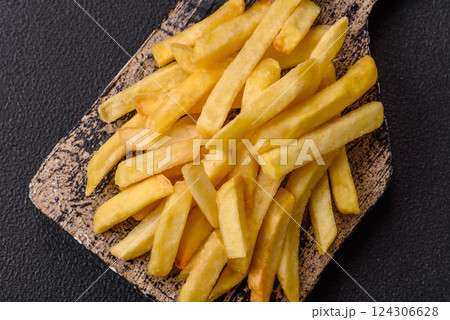 Delicious crispy French fries with salt and spices 124306628