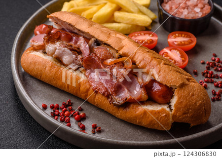 Delicious juicy hot dog with sausage, bacon, sauce, salt and spices 124306830