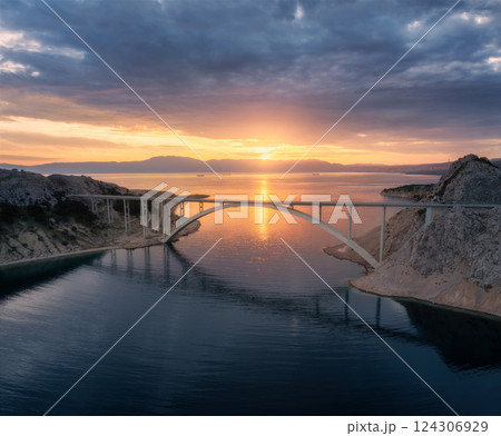 Aerial view of bridge and blue sea at colorful sunset 124306929