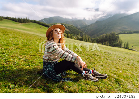 Young woman is having fun, walking through valley with stunning natural panorama. Adventure concept. Young woman is having fun, walking through valley with stunning natural panorama. Adventure concept. 124307185