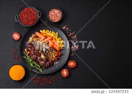 Grilled mackerel fillet pieces with vegetables, salt and spices 124307255