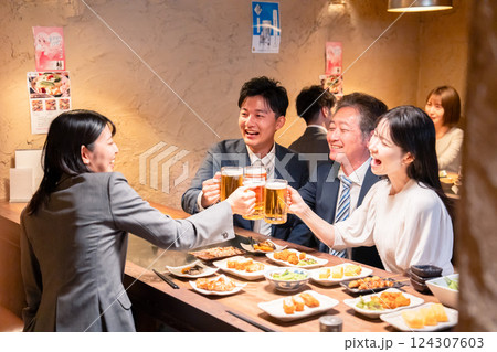 居酒屋で部署のお疲れ様会をするビジネスパーソン 124307603