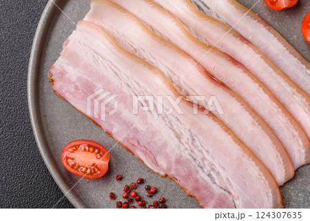 Fresh raw bacon sliced with spices and herbs 124307635
