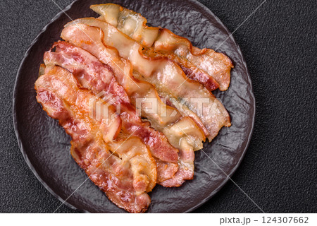 Delicious bacon in the form of slices with salt, spices and herbs 124307662