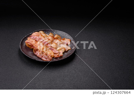 Delicious bacon in the form of slices with salt, spices and herbs Delicious bacon in the form of slices with salt, spices and herbs 124307664