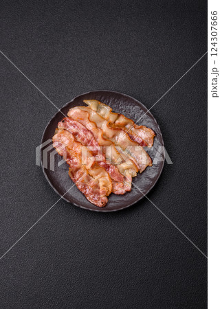 Delicious bacon in the form of slices with salt, spices and herbs Delicious bacon in the form of slices with salt, spices and herbs 124307666