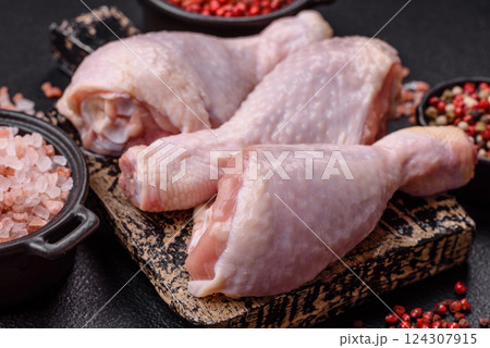 Raw chicken legs with salt, spices and herbs Raw chicken legs with salt, spices and herbs 124307915