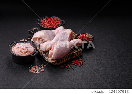Raw chicken legs with salt, spices and herbs 124307918