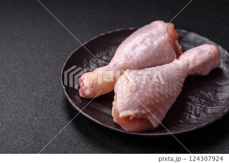 Raw chicken legs with salt, spices and herbs Raw chicken legs with salt, spices and herbs 124307924