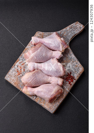 Raw chicken legs with salt, spices and herbs Raw chicken legs with salt, spices and herbs 124307936