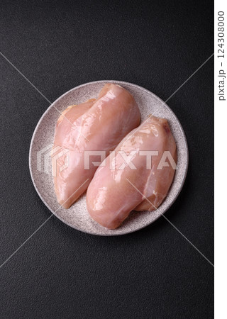 Fresh chicken fillet on a dark concrete table with spices and herbs 124308000