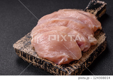 Fresh chicken fillet on a dark concrete table with spices and herbs 124308014