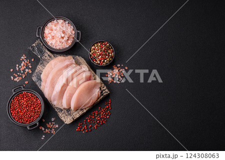 Fresh chicken fillet on a dark concrete table with spices and herbs 124308063