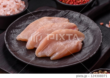 Fresh chicken fillet on a dark concrete table with spices and herbs 124308071