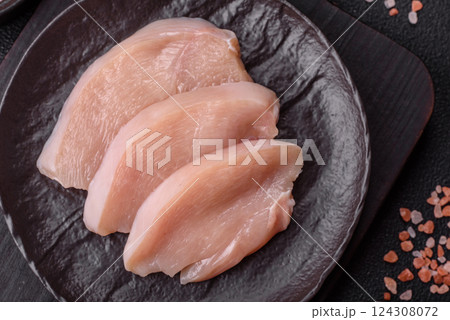 Fresh chicken fillet on a dark concrete table with spices and herbs 124308072