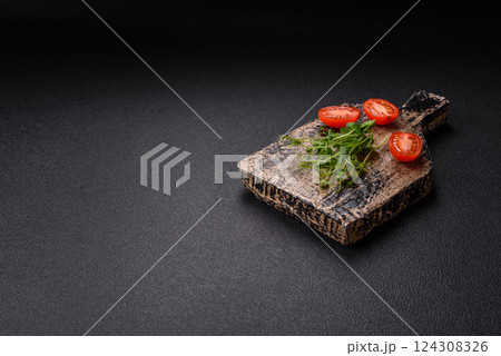 Sprigs of green fresh microgreen peas on wooden cutting board 124308326