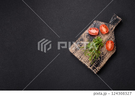 Sprigs of green fresh microgreen peas on wooden cutting board 124308327