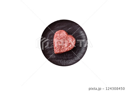 Raw beef or pork burger patty in the shape of a heart 124308450