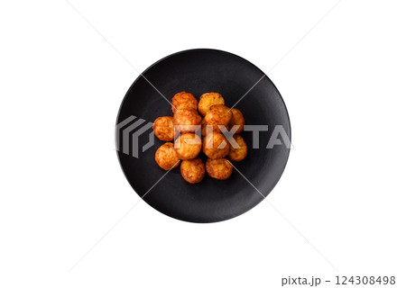 Delicious fried potato balls or croquettes with salt, spices and herbs 124308498