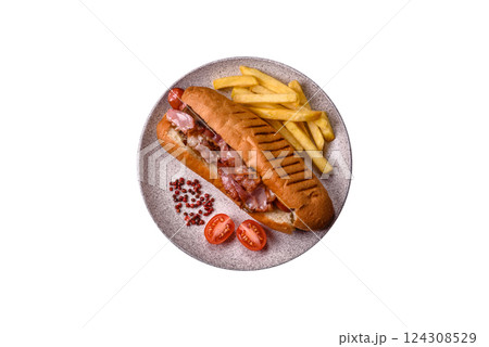 Delicious juicy hot dog with sausage, bacon, sauce, salt and spices Delicious juicy hot dog with sausage, bacon, sauce, salt and spices 124308529