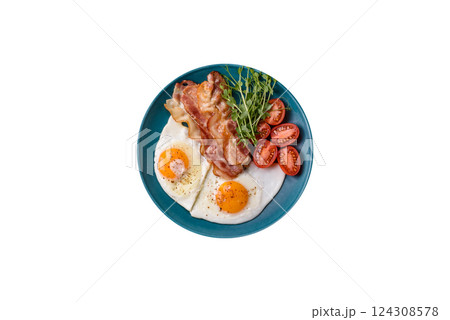 A hearty breakfast with fried eggs, bacon, tomatoes, microgreens 124308578