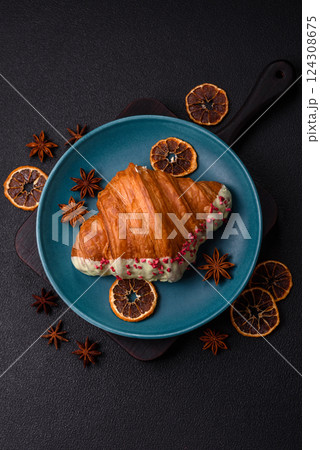 Crispy sweet red croissant with pistachio, raspberry and strawberry 124308675