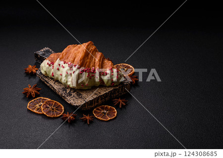 Crispy sweet red croissant with pistachio, raspberry and strawberry 124308685
