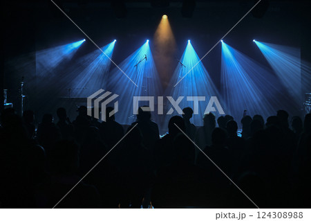 Concert performance illuminated by striking blue lights with a captured audience 124308988