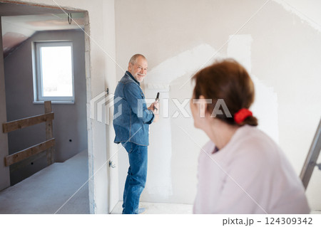 Senior couple renovating their home, a shared retirement activity. 124309342